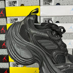Black Balenciaga unisex sneaker, quarter view with mesh upper, lace-up, and thick tread sole