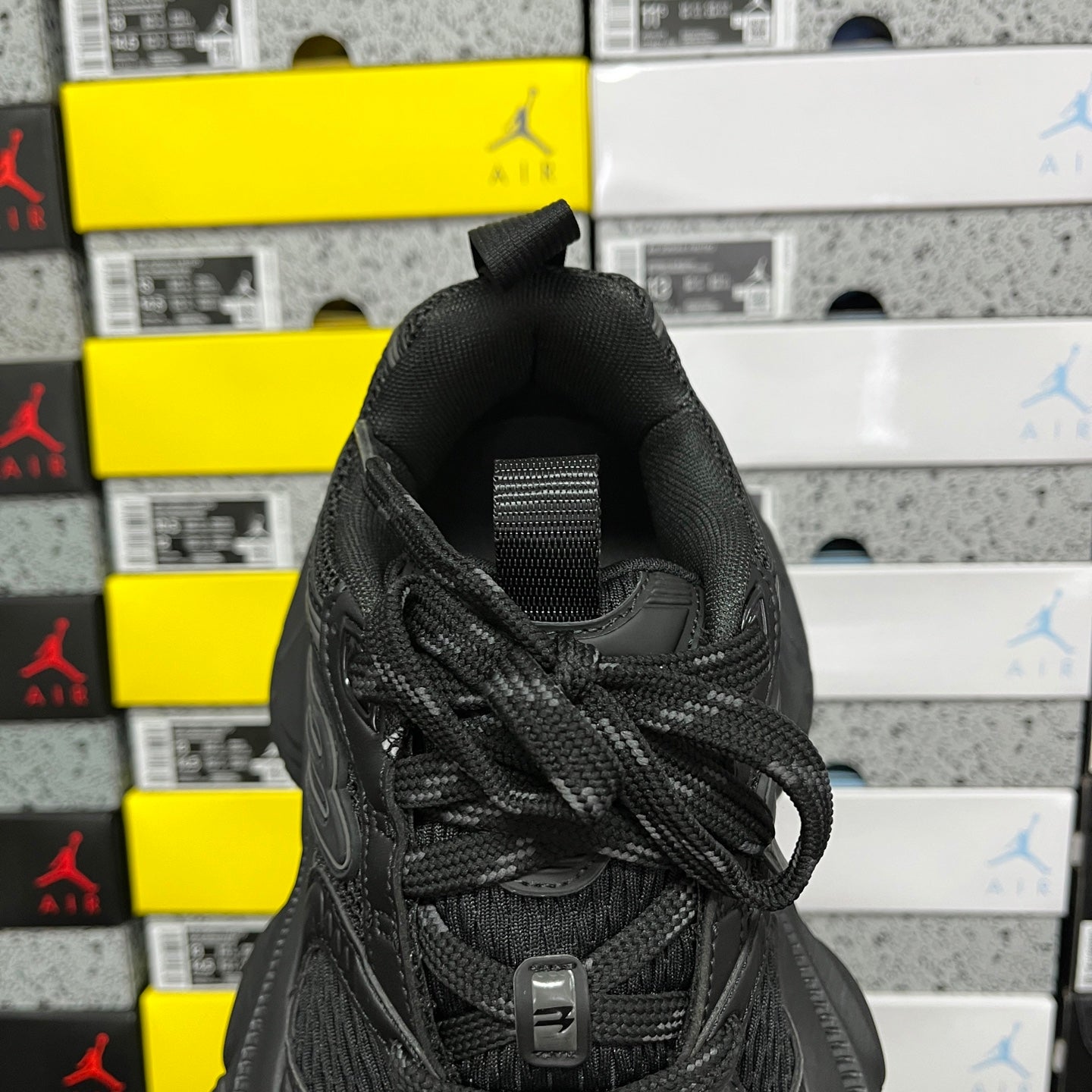 Black Balenciaga unisex sneaker, heel and side view with lace-up upper and padded collar