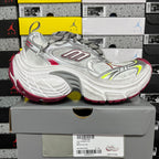 Silver lace-up sneaker with red side stripe and neon green accents, chunky sole