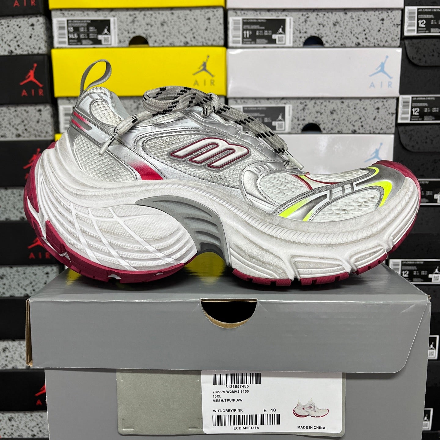 Silver lace-up sneaker with red side stripe and neon green accents, chunky sole