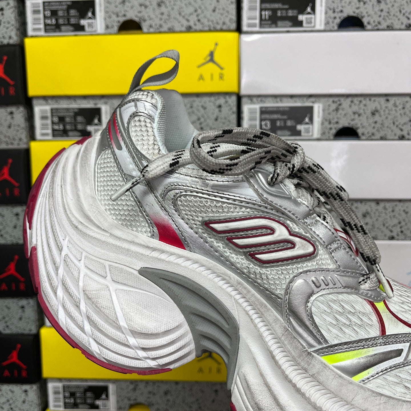Silver lace-up sneaker with red detailing and neon green accents, thick sole
