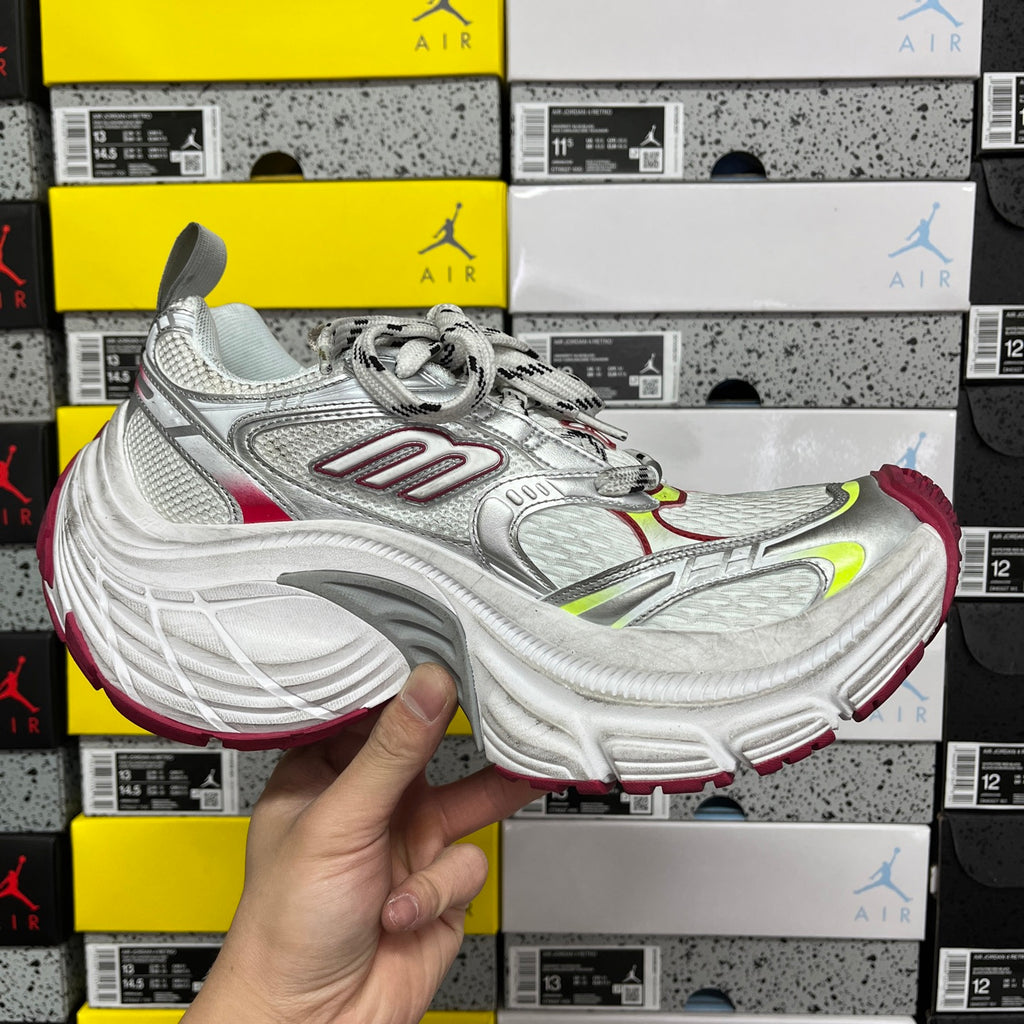 Silver lace-up sneaker with red and neon green details, low profile front