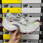 Silver lace-up sneaker with red and neon green details, low profile front