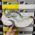 Silver sneaker with red and neon green paneling, lace-up front and cushioned sole