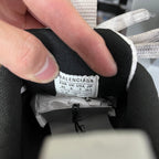 Inside label on a gray shoe tongue showing size and brand information