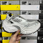Silver lace-up running shoes shown from side with chunky performance sole