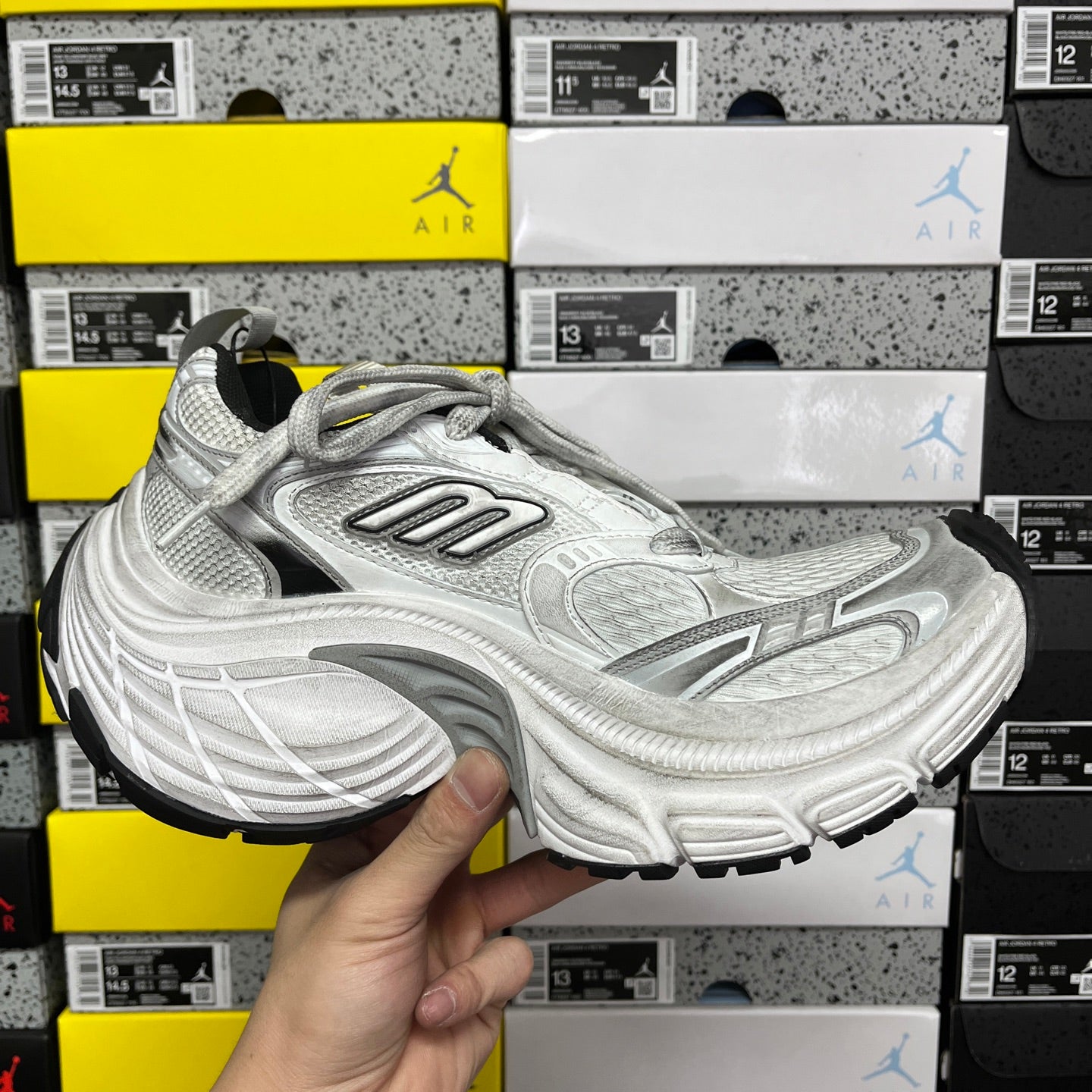 Silver lace-up running shoes shown from side with chunky performance sole