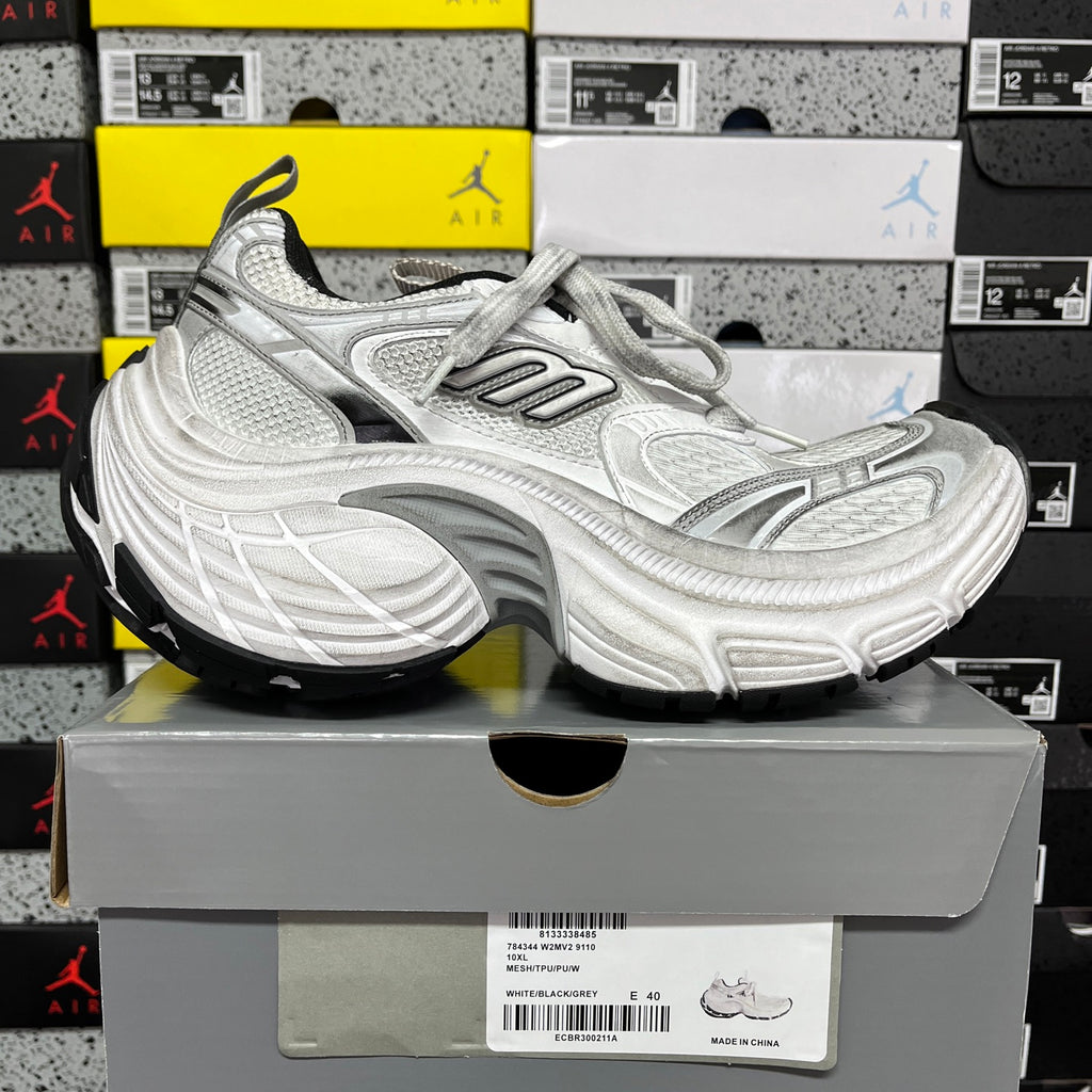 Silver lace-up running shoes with chunky sole and mesh-textured upper