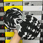 Silver and black outsole view of a lace-up running shoe with deep traction