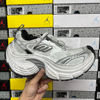 Silver and gray unisex running shoes with lace-up closure and cushioned sole