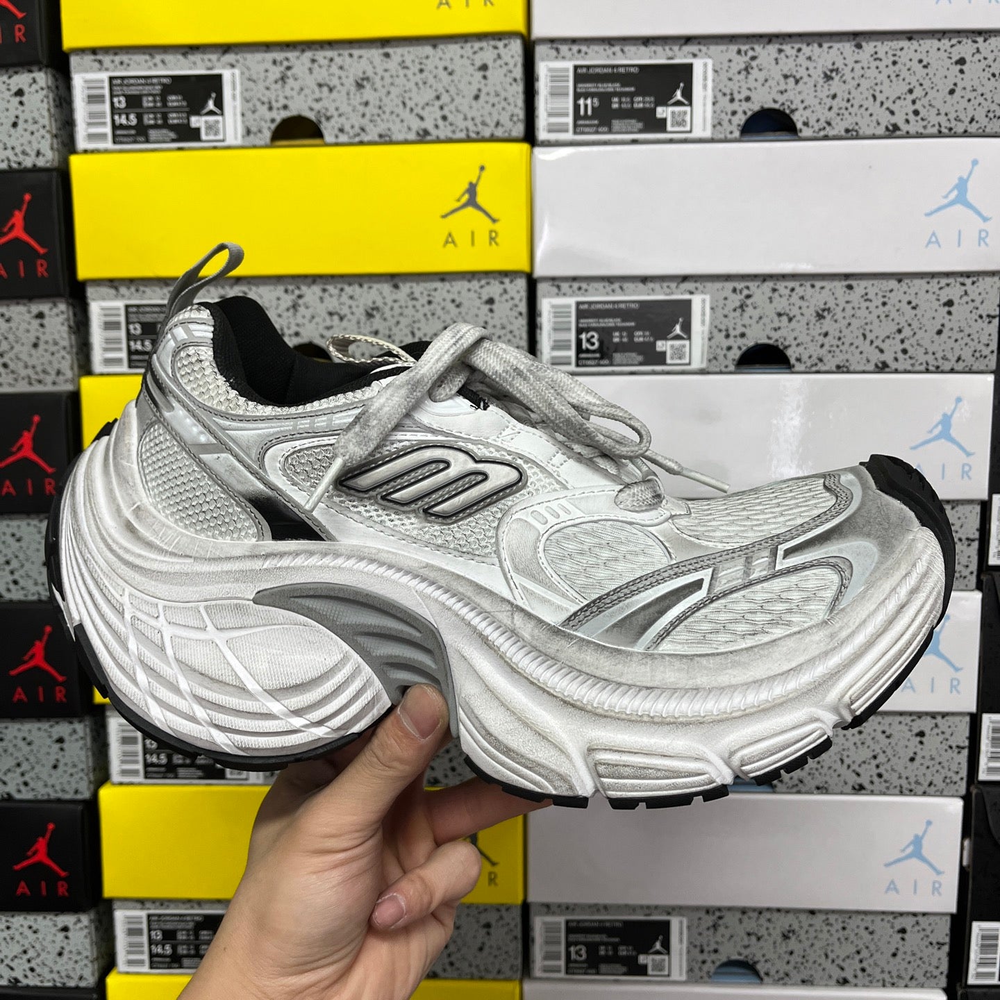 Silver and gray unisex running shoes with lace-up closure and cushioned sole