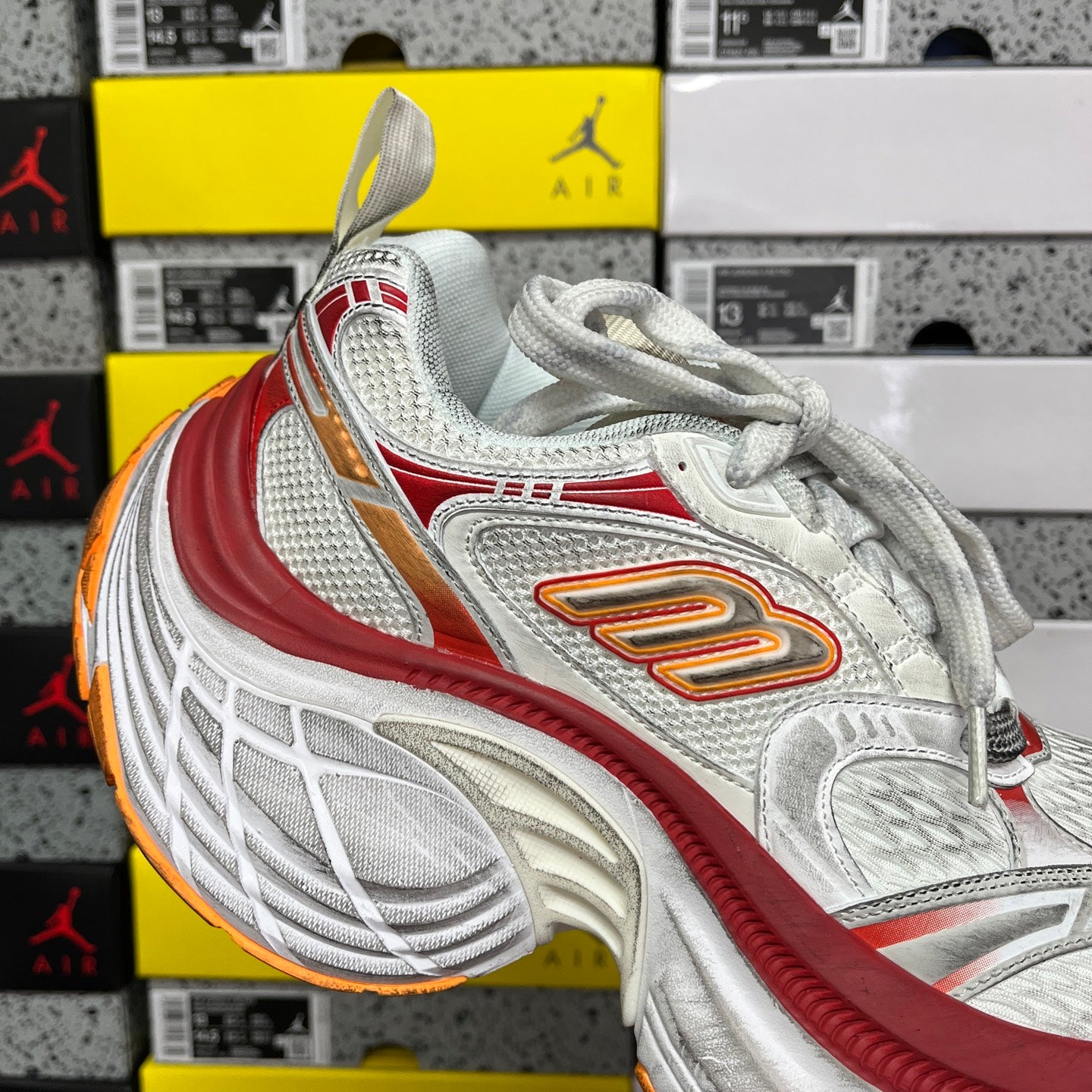 Balenciaga running shoe, white mesh with red stripe and orange logo, chunky outsole
