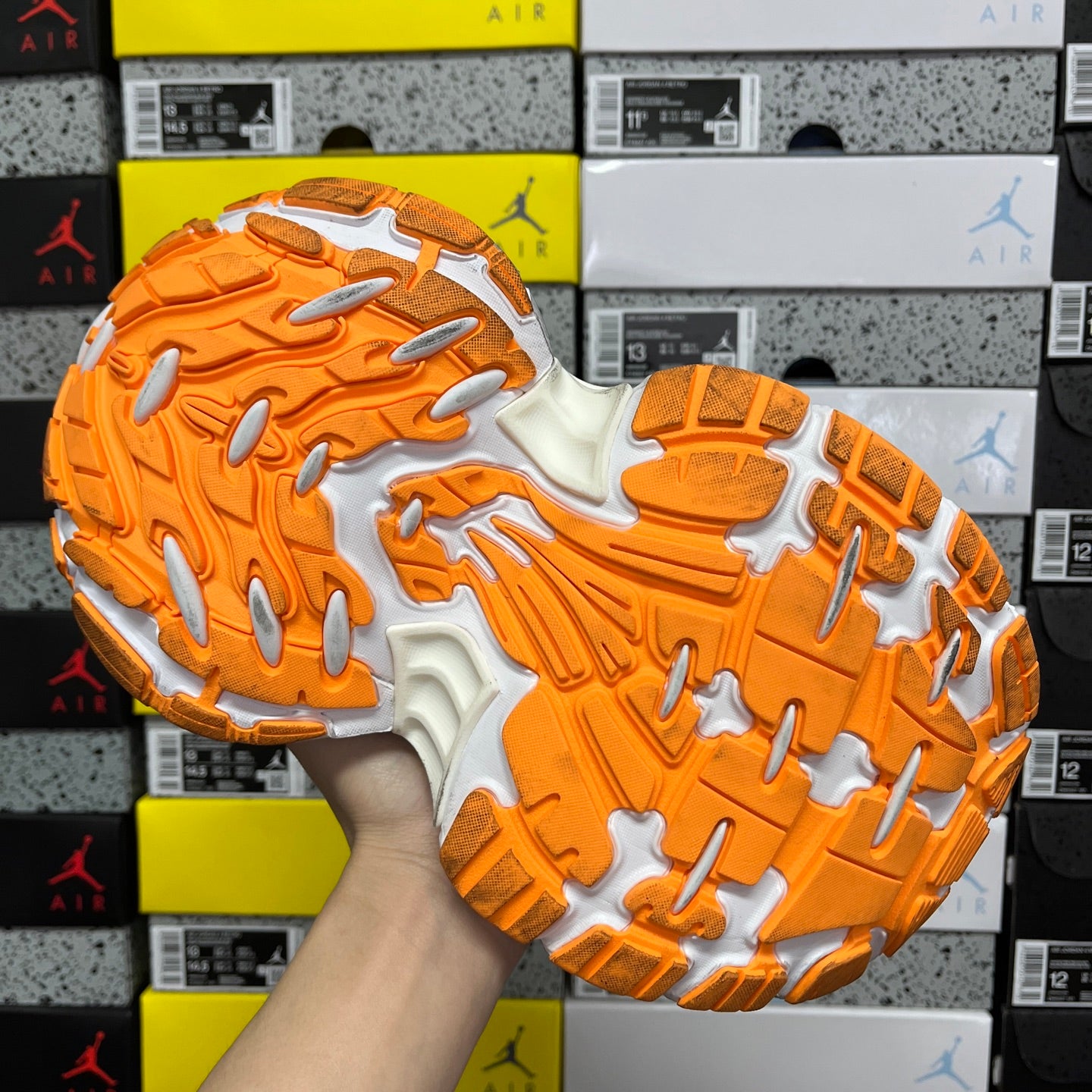 Balenciaga running shoe outsole, orange rubber tread with white cushioning zones