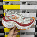 Balenciaga running shoe: white/silver upper, red accents, orange outsole tread