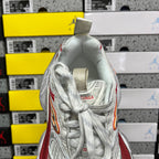 Balenciaga running shoe heel view, white mesh collar with red side stripe and orange trim
