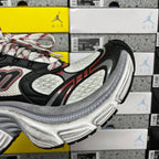 Black and white chunky running sneaker with red piping and textured mesh upper