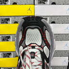 Sneaker tongue and lacing area in white mesh with black side panels and red accents