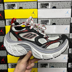 Black, red and white chunky running sneaker with lace-up front and mesh panels