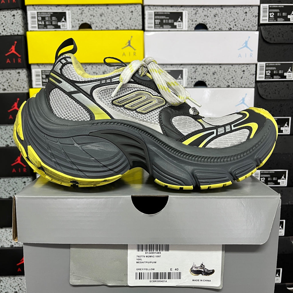 Side view lace-up sneaker in dark gray and neon yellow with silver-gray upper.