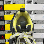 Shoe heel and collar with neon yellow lining and black heel pull tab.