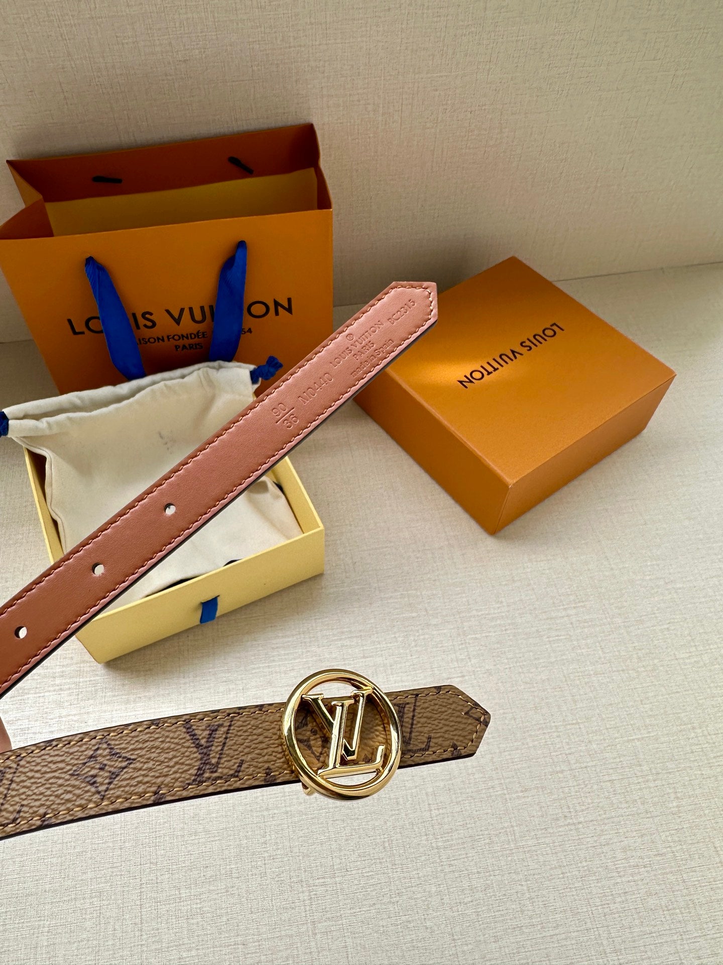 Louis Vuitton monogram belt with gold buckle and lighter brown strap holes