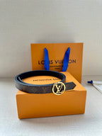 Monogram belt with round silver-tone LV buckle on orange gift box