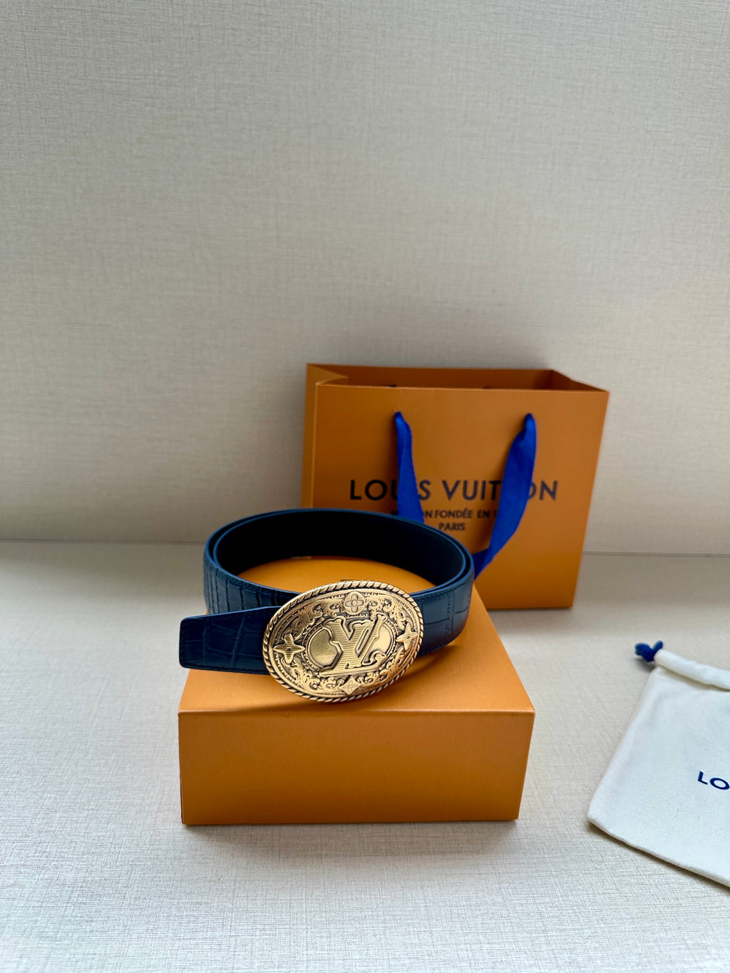 Louis Vuitton dark blue leather belt with gold oval logo buckle