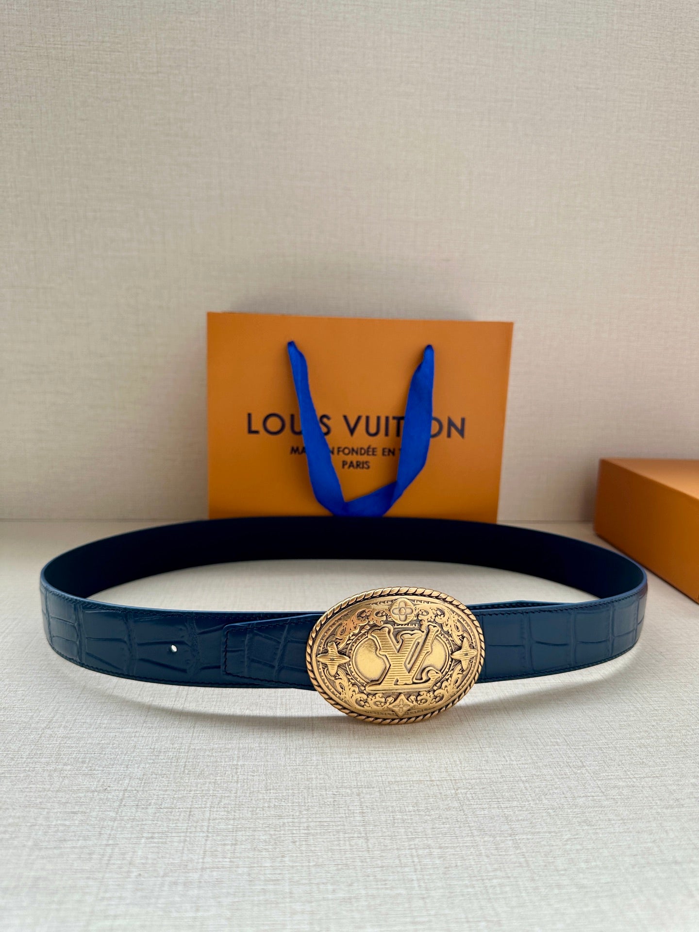 Louis Vuitton leather belt in dark blue with gold oval LV logo buckle