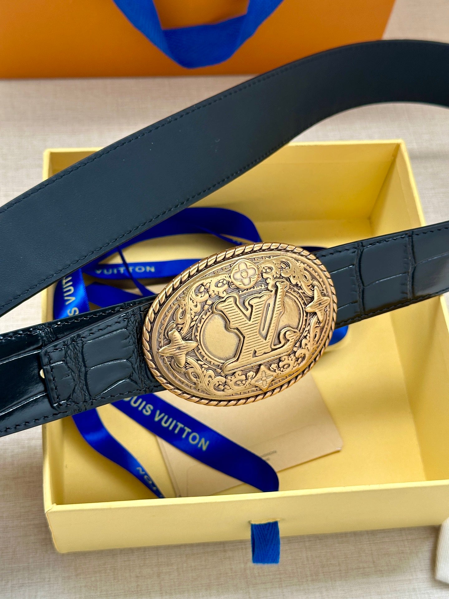 Louis Vuitton belt, dark blue leather with oval gold-tone logo buckle and adjustable strap holes