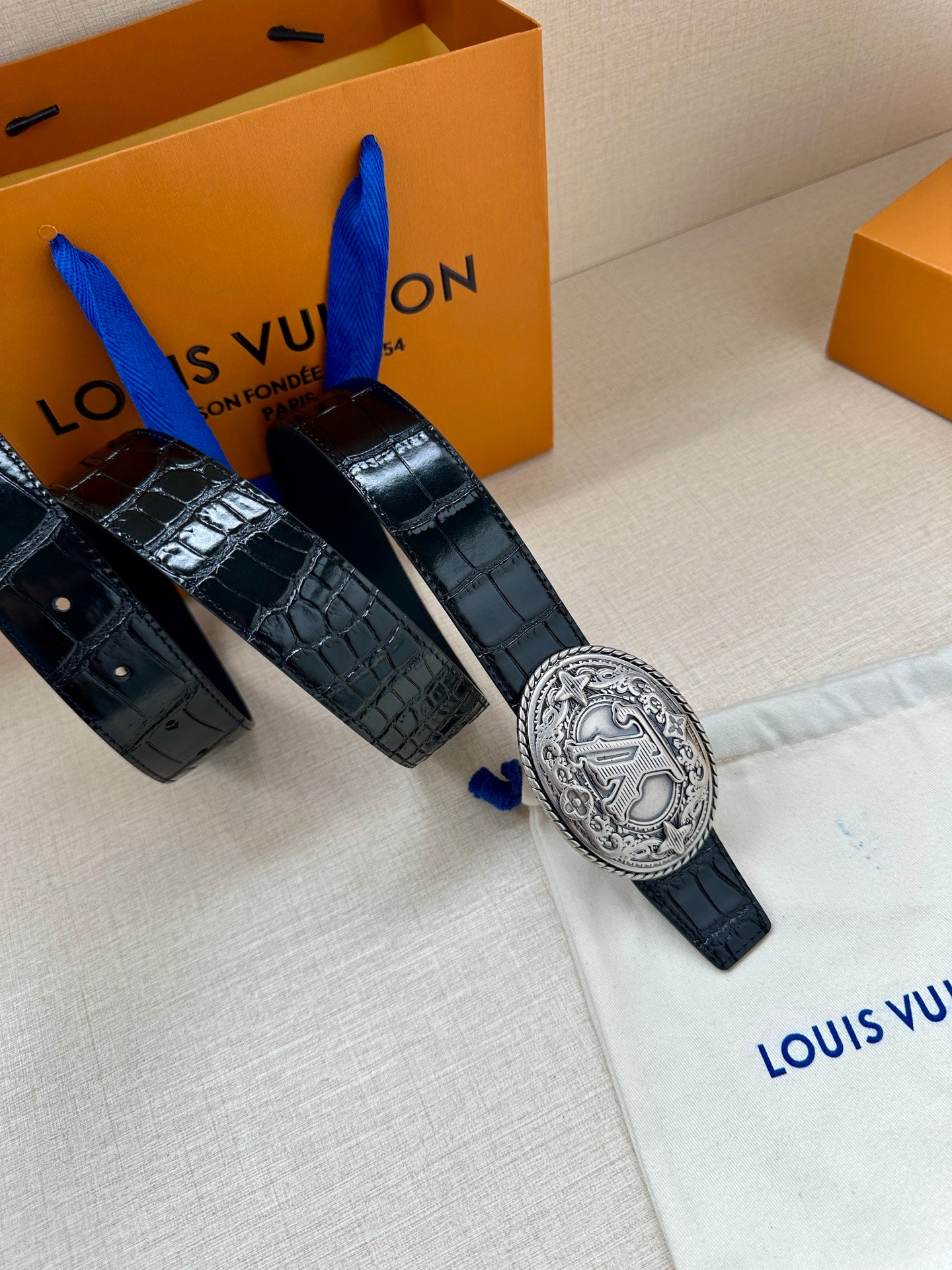 Louis Vuitton belt with dark blue croc-embossed leather and oval silver-tone logo buckle