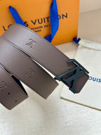 Louis Vuitton belt detail: dark brown strap with LV buckle and engraved emblems