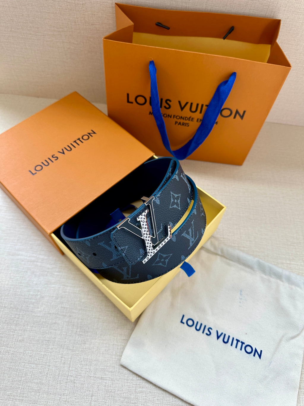 Louis Vuitton belt with navy monogram strap and gold buckle with dust bag