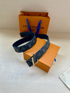 Louis Vuitton belt with navy monogram strap and gold-tone buckle