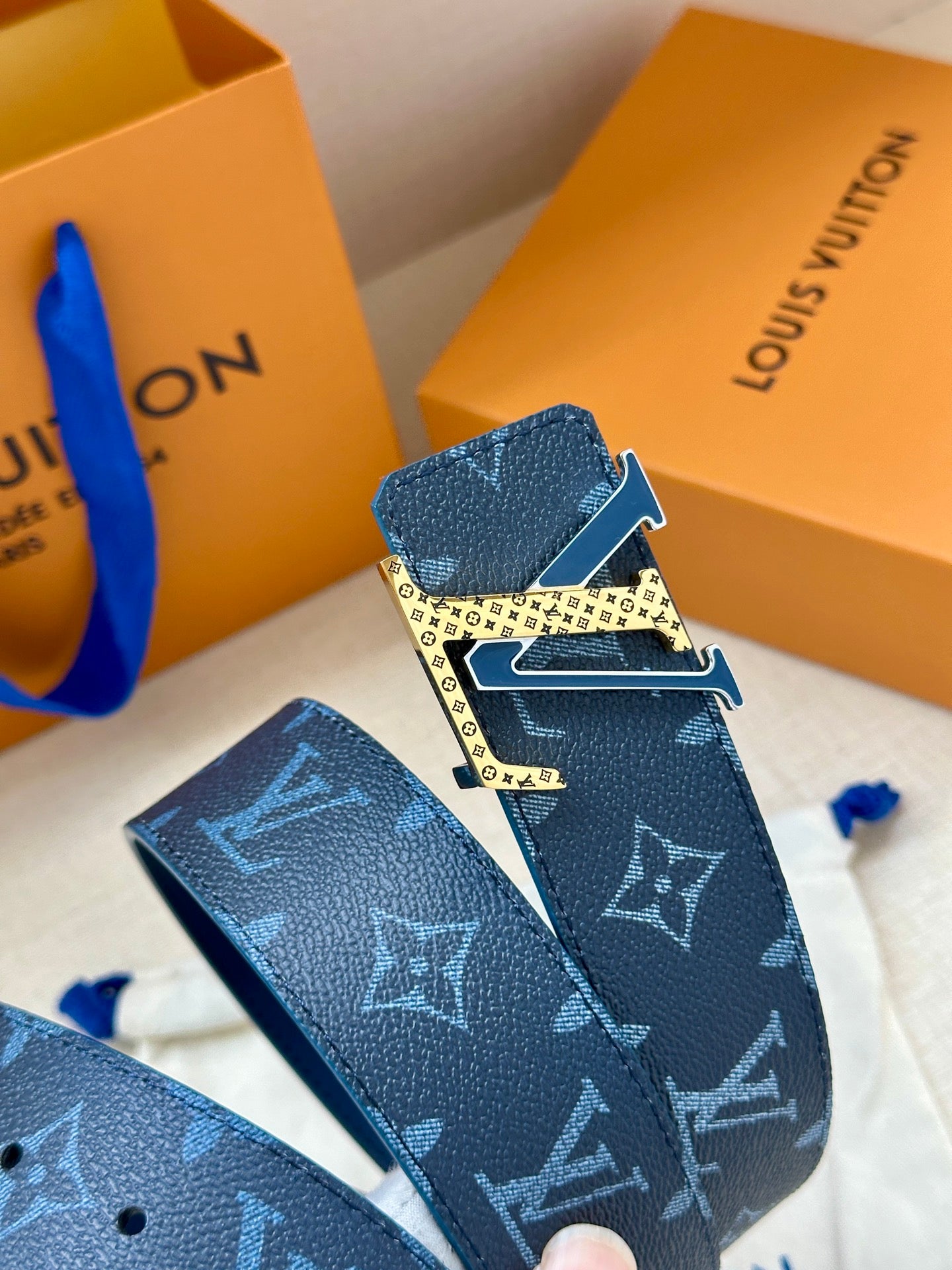 Louis Vuitton belt buckle and navy monogram strap with gold hardware