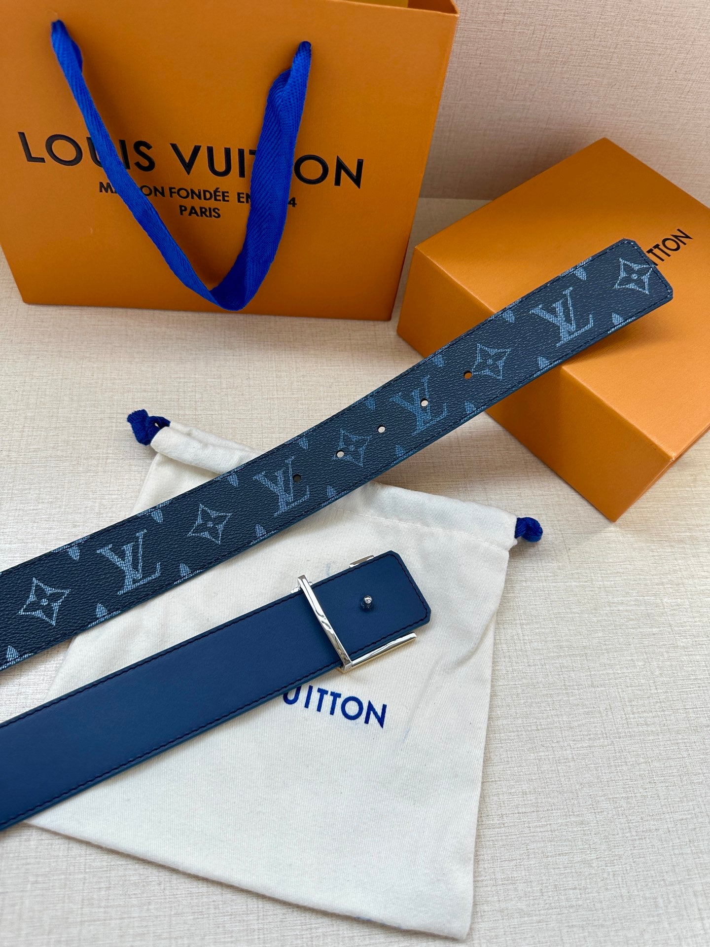Louis Vuitton belt with navy monogram strap and rectangular navy buckle