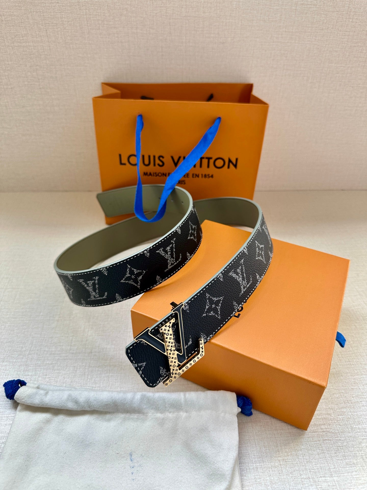 Monogram belt with dark LV pattern strap and gold-tone buckle, olive inner leather