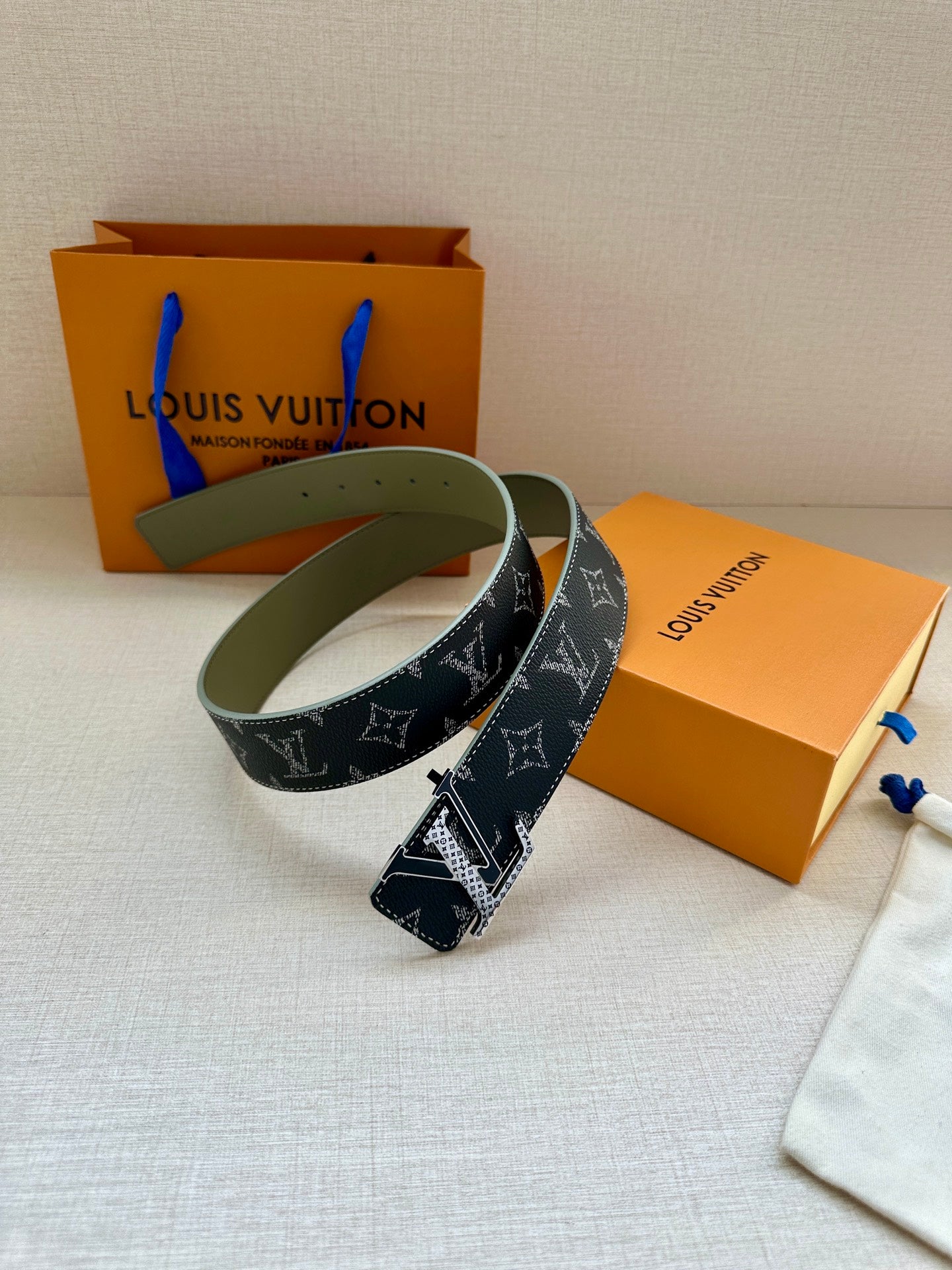 Louis Vuitton monogram belt with dark strap, gold-tone buckle and olive leather lining