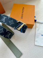 Monogram belt close-up of buckle and keeper tab on dark canvas strap