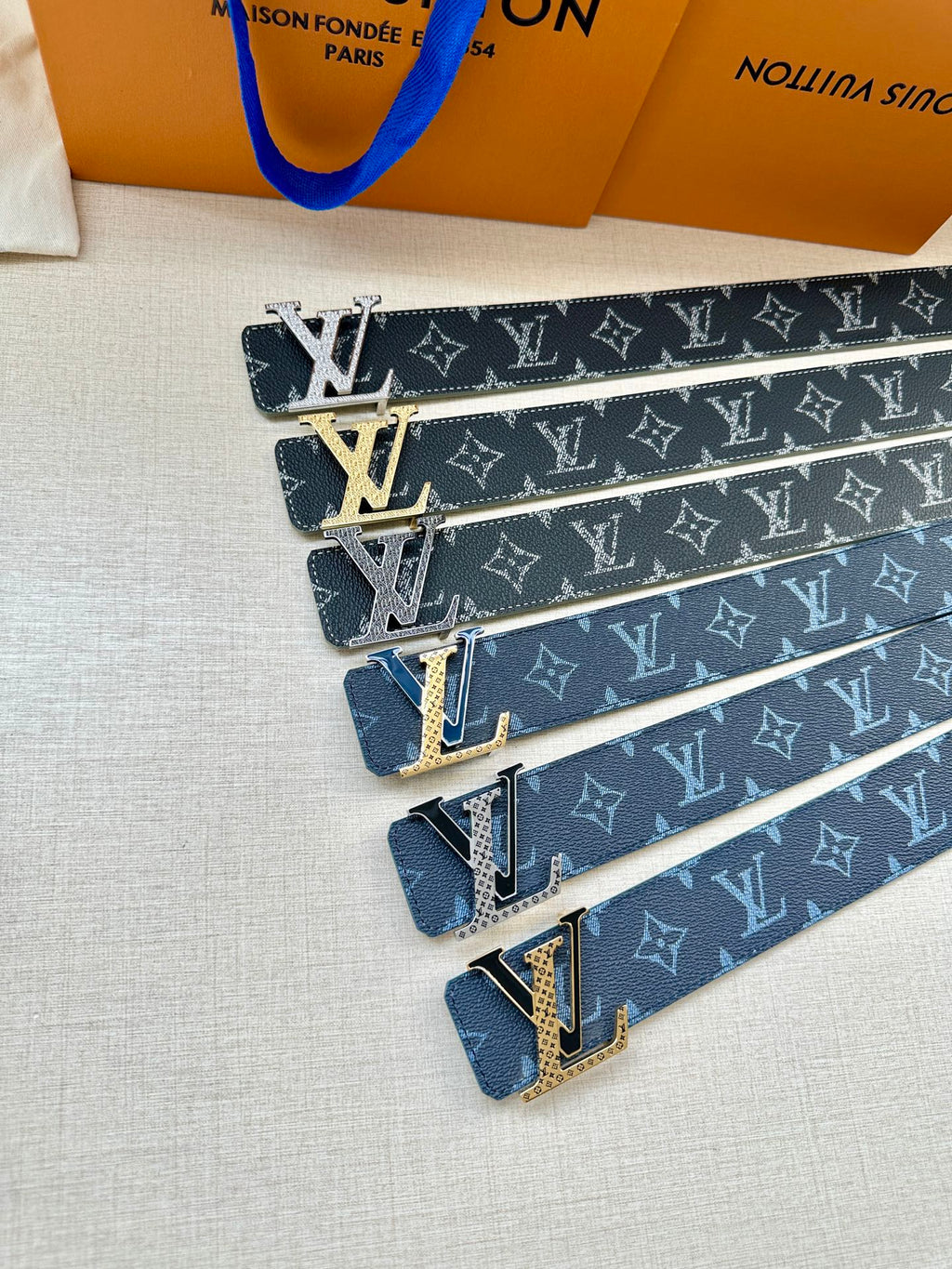 Set of dark monogram belts with gold-tone buckles, LV patterned straps