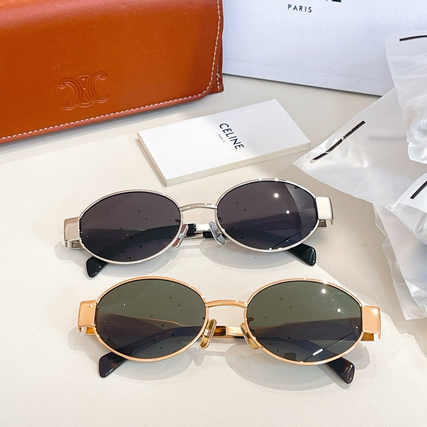 Round sunglasses set with silver and gold frames and dark lenses