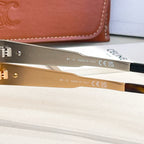 Gold-tone sunglasses showing inside arm with printed text and CE marking