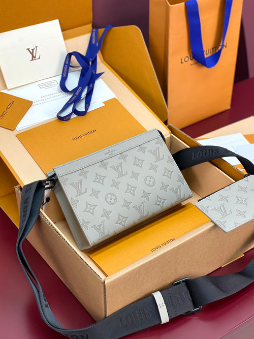 Louis Vuitton small crossbody bag with light blue monogram pattern and adjustable strap