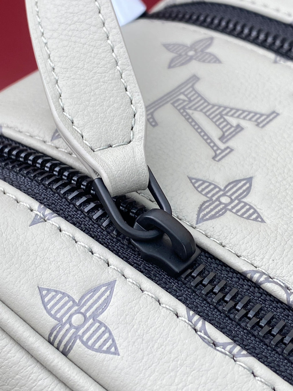 Louis Vuitton monogram toiletry bag zipper pull with navy zipper and stitched seam