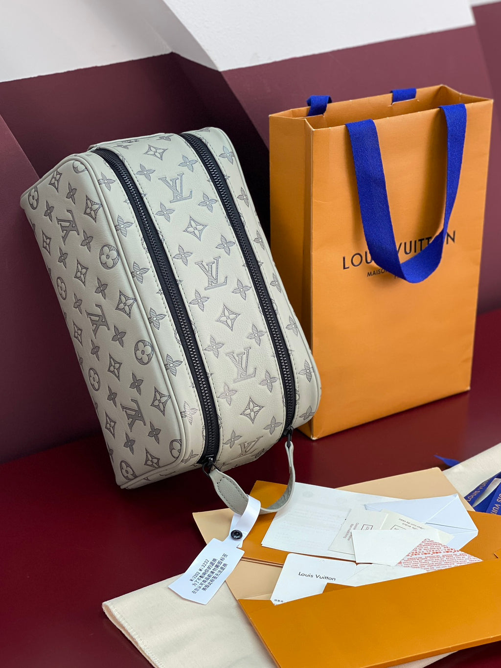 Louis Vuitton monogram toiletry bag, light gray with navy zipper and hanging tag