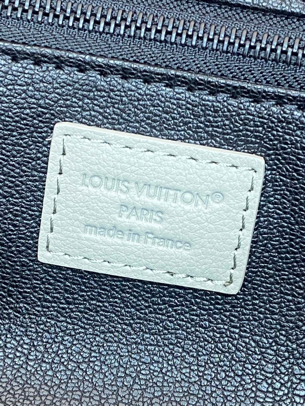 Louis Vuitton monogram toiletry bag leather label with stitched text