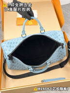 Light-blue Louis Vuitton monogram duffel bag with black-lined interior opening