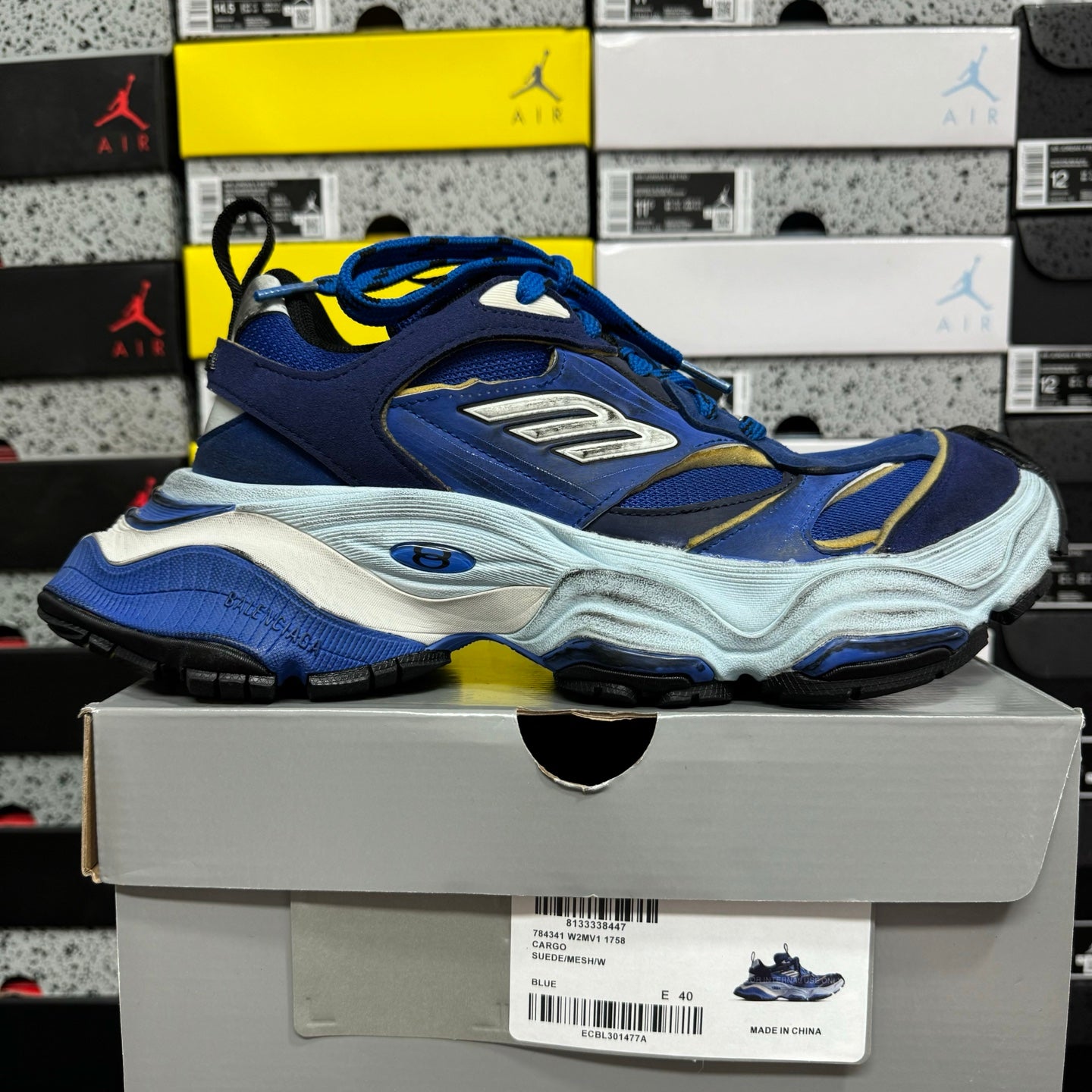 Balenciaga lace-up sneakers on box, blue upper with gold trim and white midsole