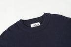 Crewneck knit sweater neckline with Stone Island logo patch on the collar.