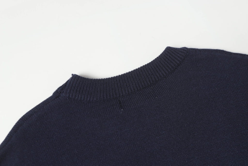 Dark navy crewneck knit sweater with ribbed collar and shoulder detail.