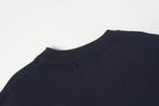Dark navy crewneck knit sweater with ribbed collar and shoulder detail.